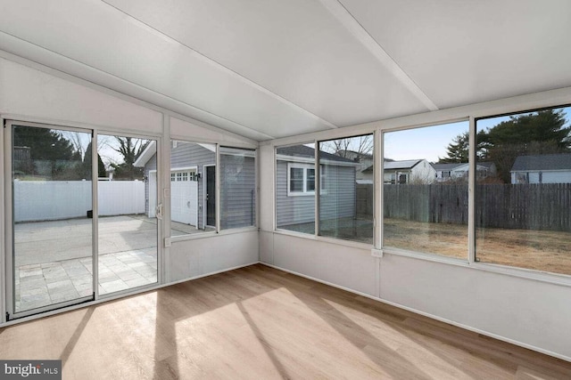 unfurnished sunroom with vaulted ceiling