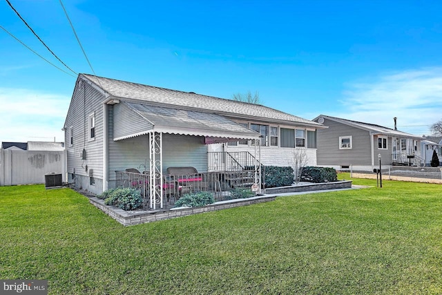 view of front of home with a front yard and cooling unit