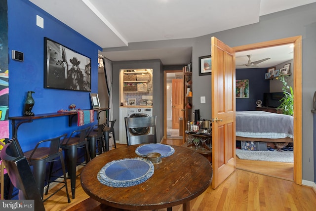 dining space featuring hardwood / wood-style flooring and separate washer and dryer