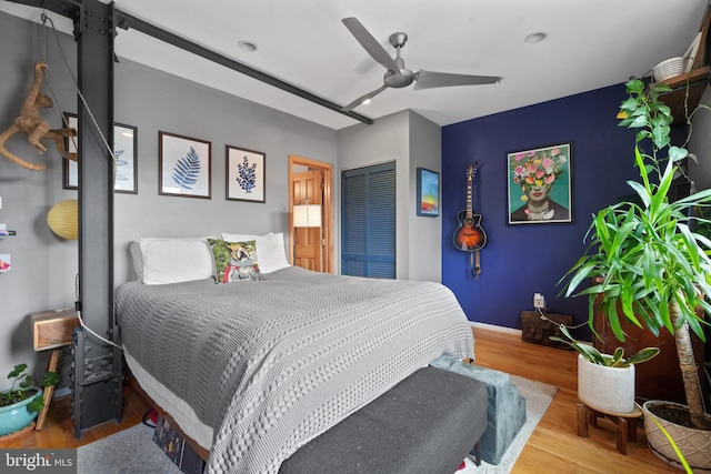 bedroom featuring hardwood / wood-style floors, a closet, and ceiling fan