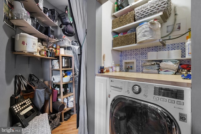 laundry room with washer / clothes dryer and light hardwood / wood-style floors