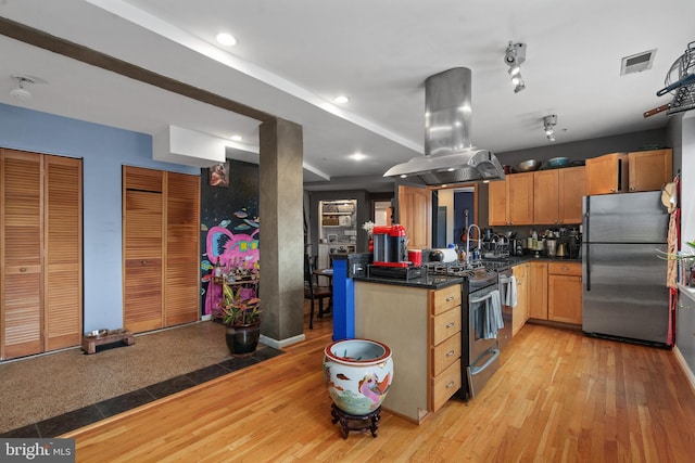 kitchen featuring backsplash, island range hood, light hardwood / wood-style flooring, and stainless steel appliances