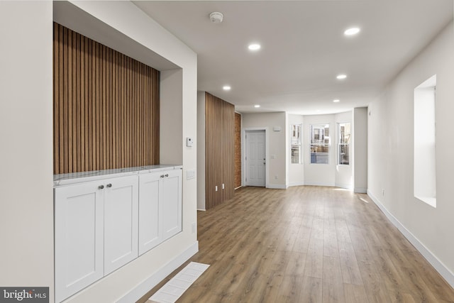 corridor with light hardwood / wood-style flooring