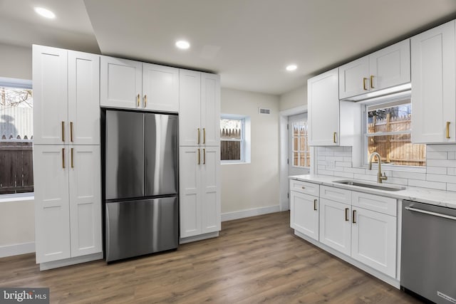 kitchen featuring appliances with stainless steel finishes, sink, and white cabinets