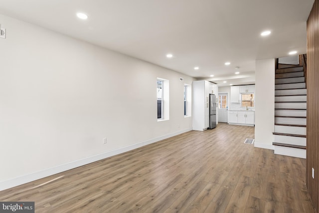 unfurnished living room featuring light hardwood / wood-style flooring