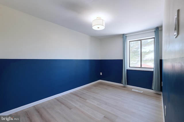 spare room with light wood-type flooring