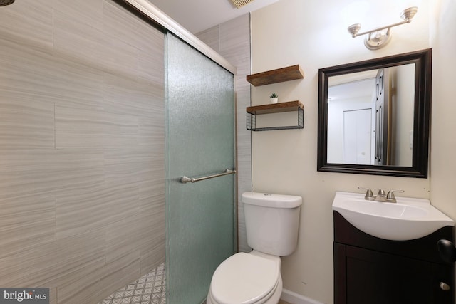 bathroom with vanity, toilet, and a shower with door