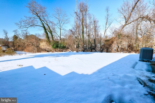 yard layered in snow with central air condition unit