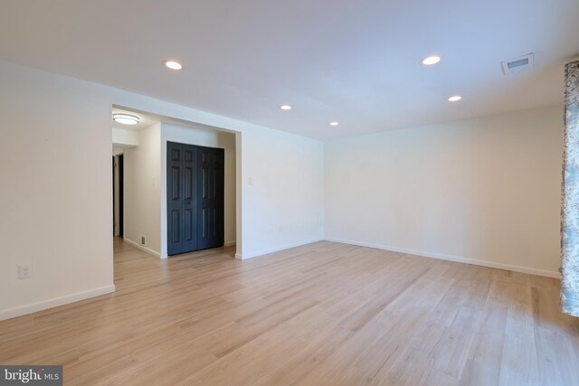 unfurnished room with recessed lighting, baseboards, and light wood finished floors