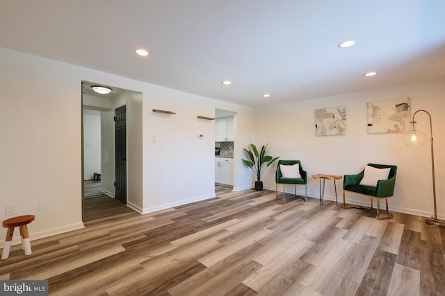 sitting room featuring recessed lighting, baseboards, and wood finished floors