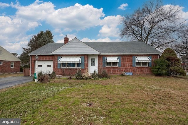 ranch-style home with a garage and a front yard