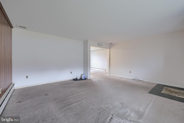 carpeted empty room featuring a baseboard radiator