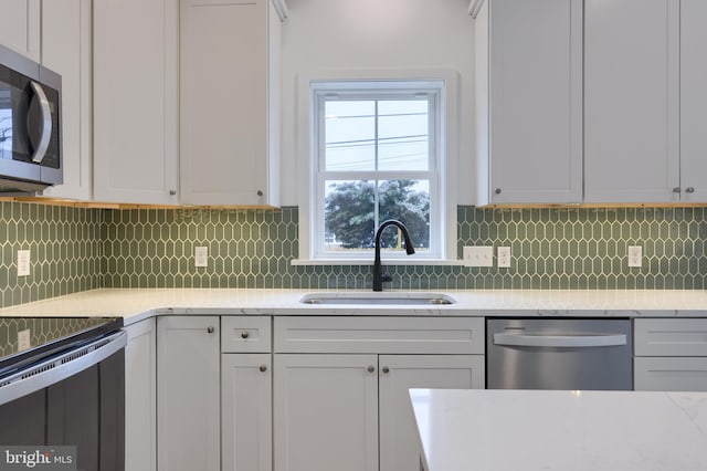 kitchen with sink, stainless steel appliances, and white cabinets