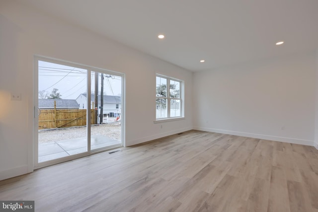 spare room featuring light wood-type flooring