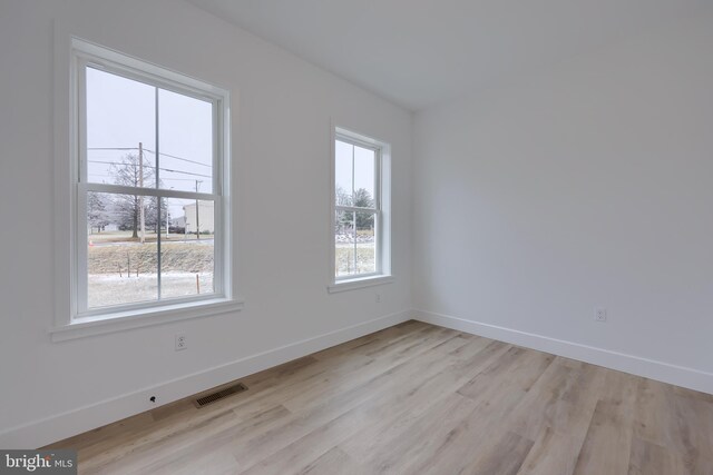 spare room featuring light hardwood / wood-style flooring