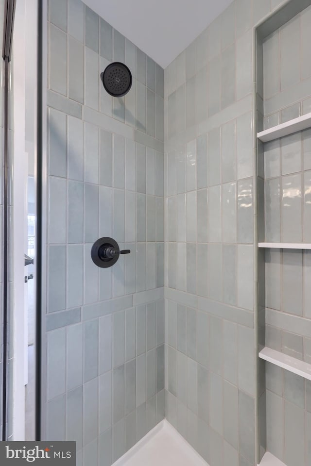 bathroom with a tile shower