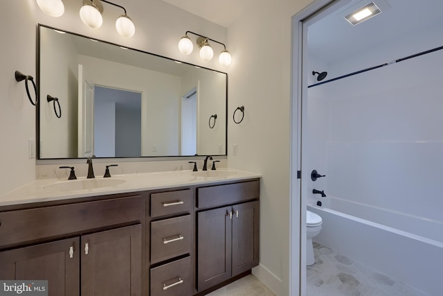 full bathroom with vanity, washtub / shower combination, and toilet