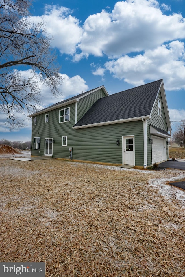 back of property featuring a garage