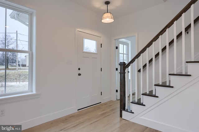 entrance foyer featuring plenty of natural light and light hardwood / wood-style flooring