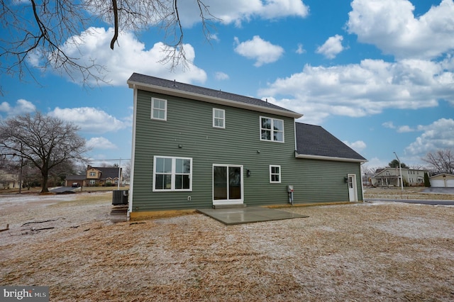 rear view of house with cooling unit and a patio