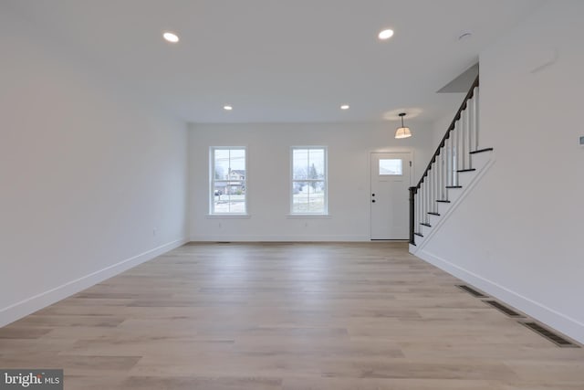 foyer entrance with light hardwood / wood-style floors