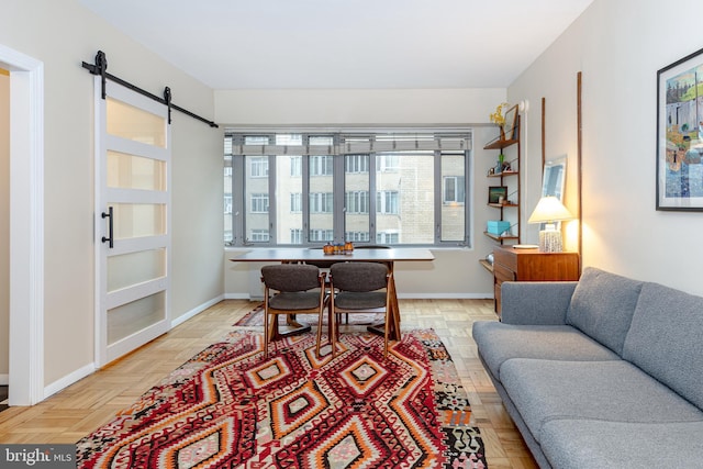 living room featuring a barn door and light parquet floors