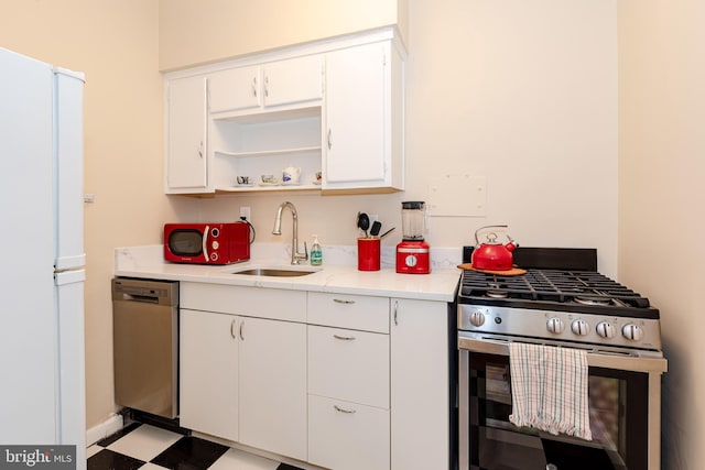 kitchen with white cabinetry, sink, and stainless steel appliances