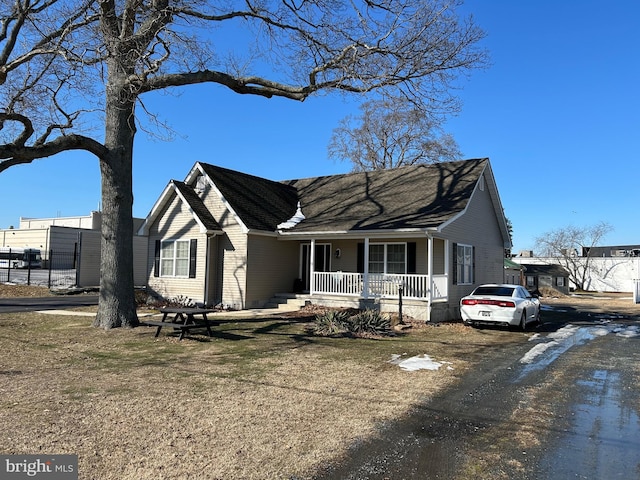 view of front of property with a front yard and covered porch