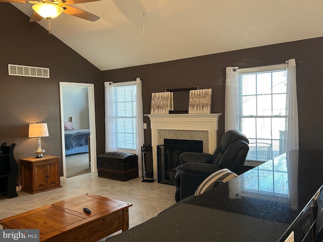 living room featuring ceiling fan and vaulted ceiling