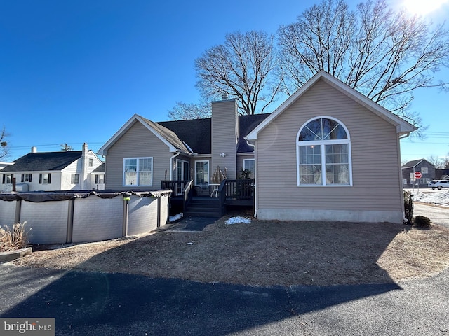 view of front of property with a swimming pool side deck