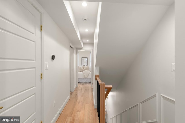 corridor with light hardwood / wood-style floors