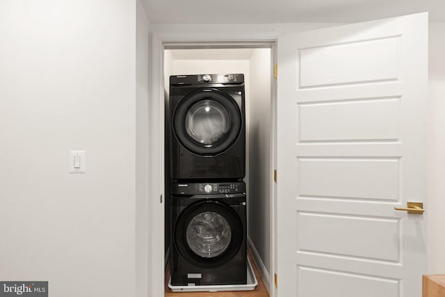 laundry area with stacked washer / dryer