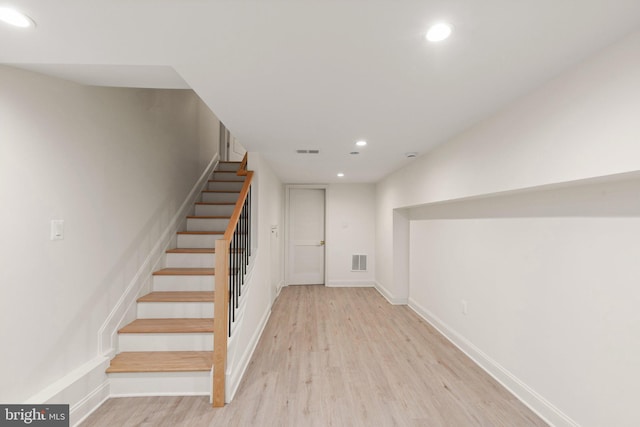 stairs with hardwood / wood-style flooring