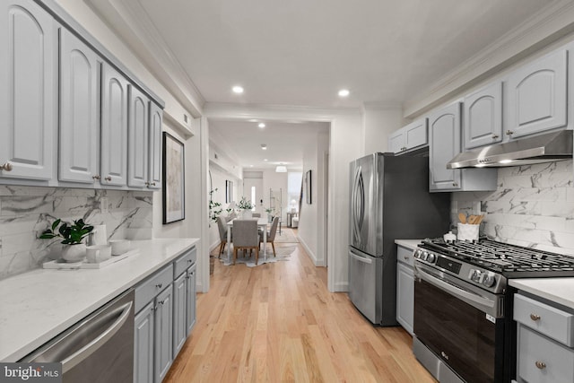 kitchen featuring gray cabinetry, ornamental molding, and stainless steel appliances