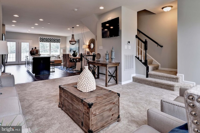 carpeted living room with baseboards, stairway, visible vents, and recessed lighting