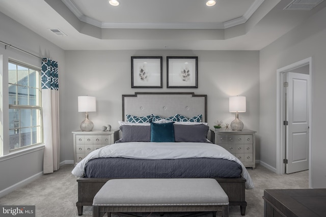 bedroom featuring visible vents, a tray ceiling, and light colored carpet