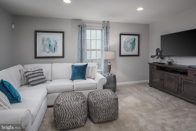 living room with recessed lighting, baseboards, and light colored carpet