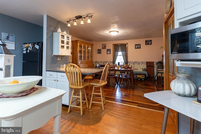 dining space with wood finished floors