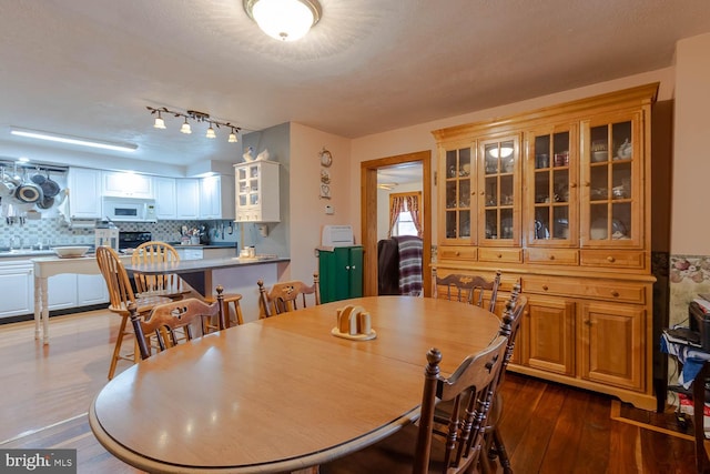 dining area with dark wood-style flooring