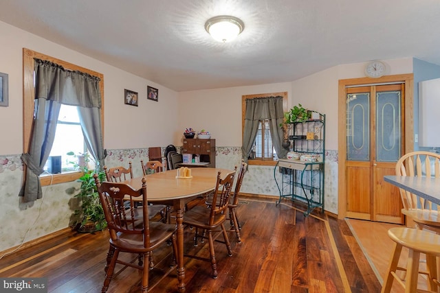 dining space featuring wainscoting and wood-type flooring