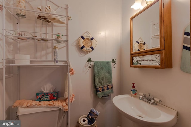 half bathroom featuring a sink and toilet