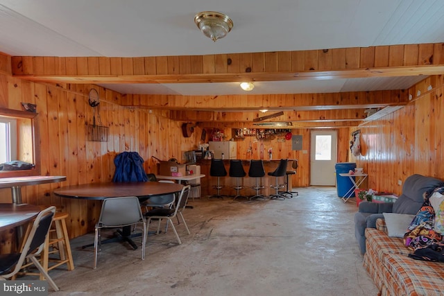 interior space featuring wood walls and a bar