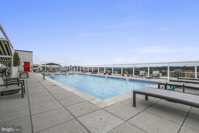 view of swimming pool with a patio and a gazebo