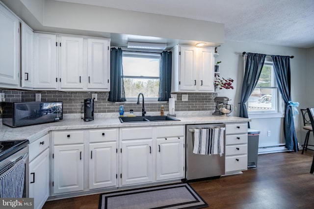 kitchen featuring sink, dark wood-type flooring, plenty of natural light, stainless steel appliances, and white cabinets