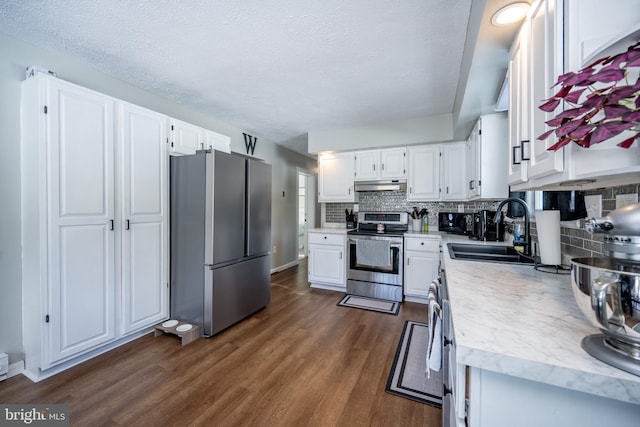 kitchen with sink, white cabinets, and appliances with stainless steel finishes