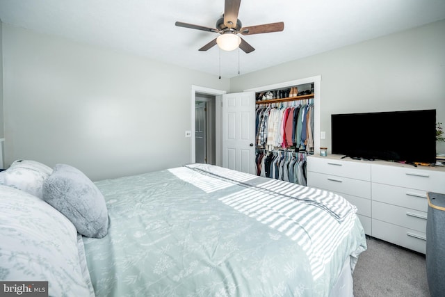 bedroom featuring light carpet, ceiling fan, and a closet