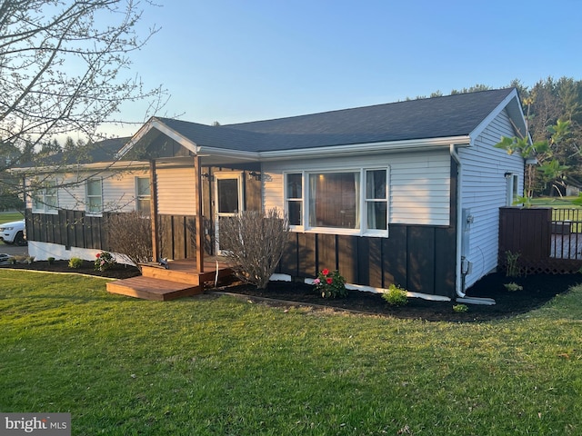 back of house with a lawn