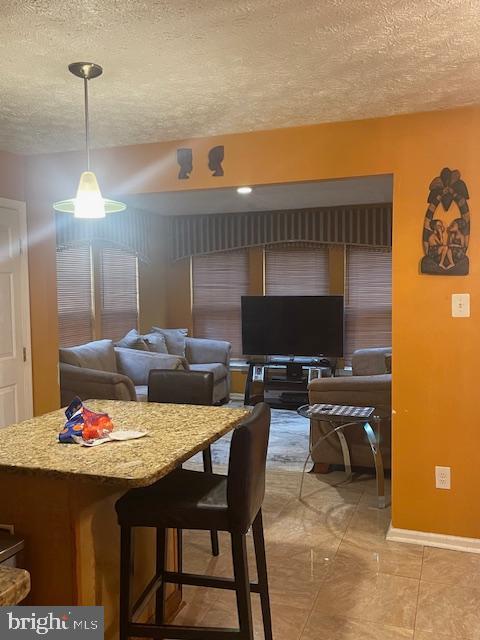 dining area featuring a textured ceiling