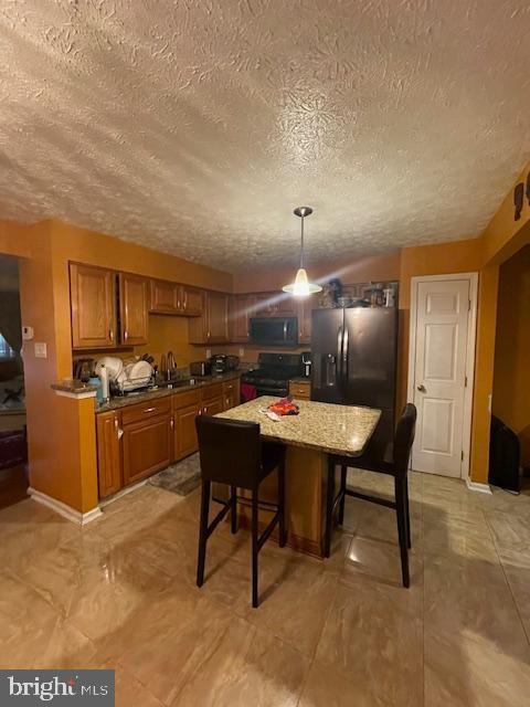 dining room with sink and a textured ceiling