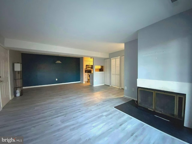 unfurnished living room featuring wood-type flooring